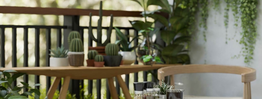a balcony with various tropical plants, funriture, coffee and a beautiful nature view