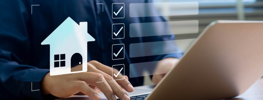 A professional organizing real estate tasks on a laptop using a digital checklist